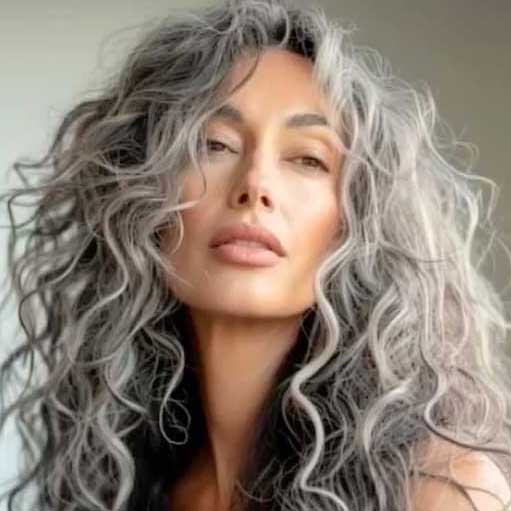 A woman with long, wavy, natural gray hair.