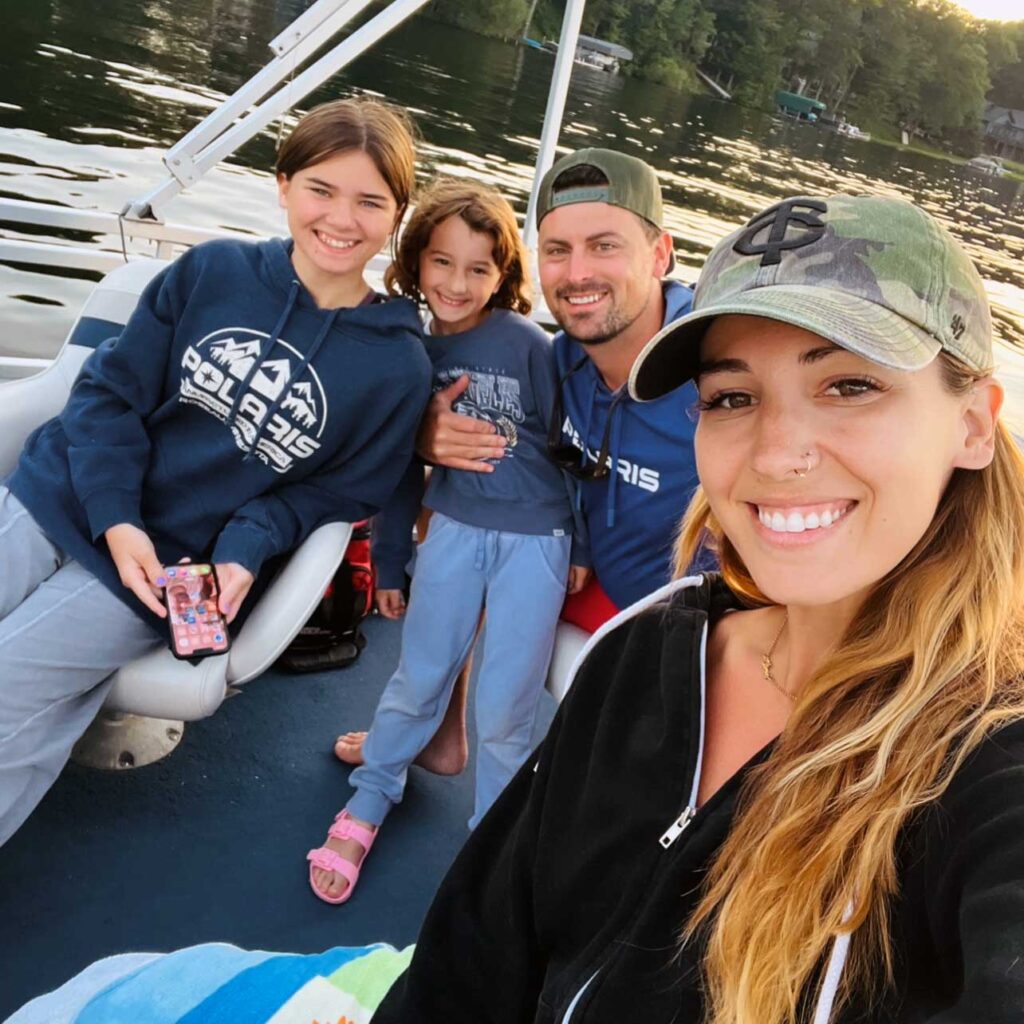 Heather out on the water with her two daughters and husband on a beautiful Minnesota summer evening,.