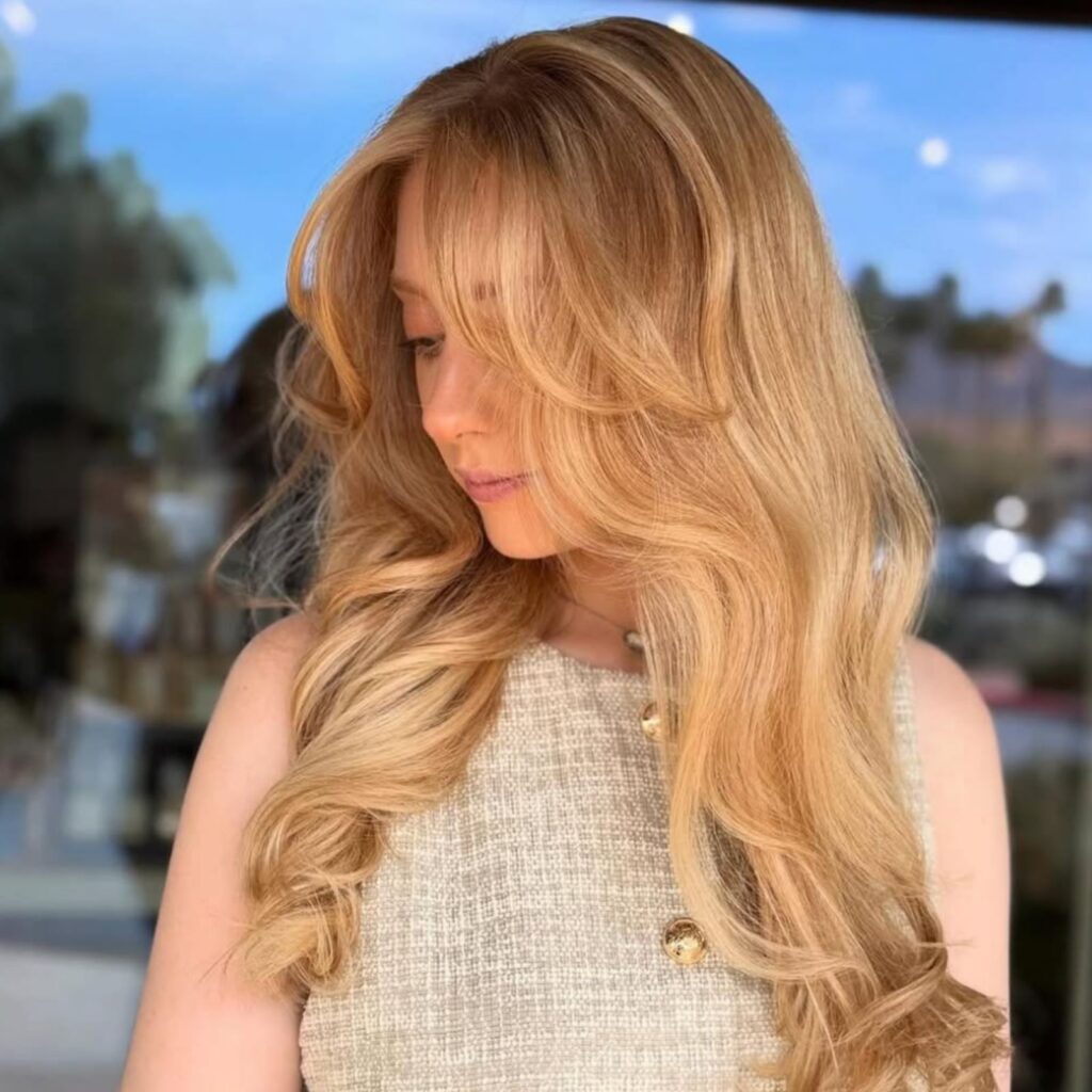 A woman with beautiful lived-in blond hair, glancing to her right