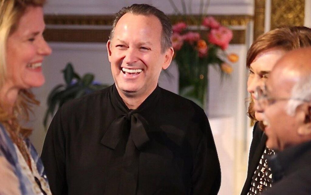 JUUT founder, David Wagner, laughing as he engages in a joyful conversation with JUUT clients