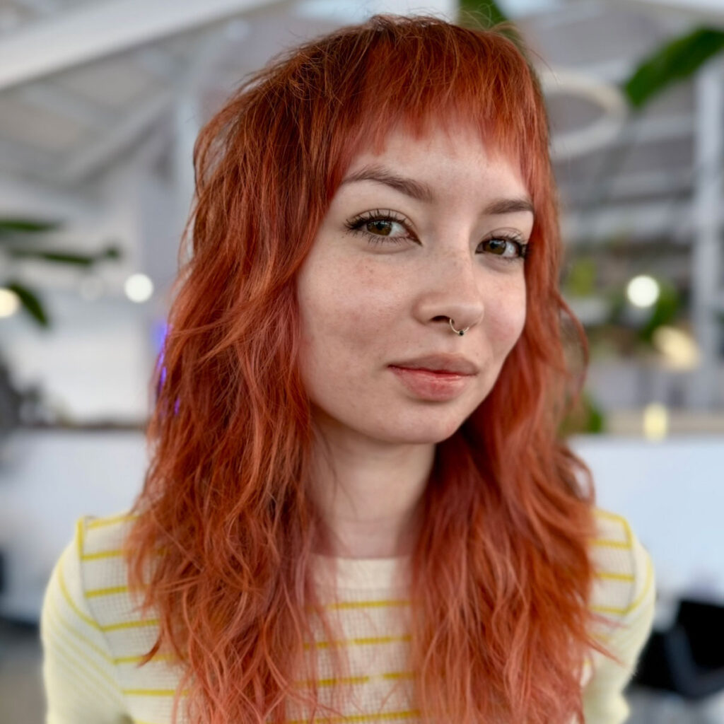 A young woman with red, wavy 2c and 3a hair after a curly hair routine