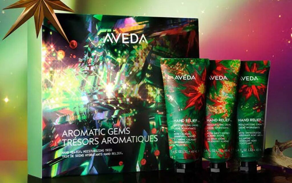 An Aveda hand relief holiday gift set with three products set against an aurora borealis background.